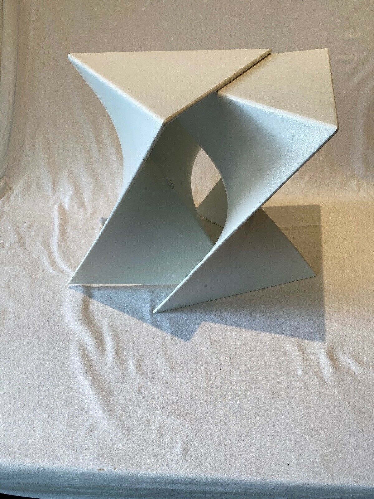 Pair of unmarked triangular white design stools