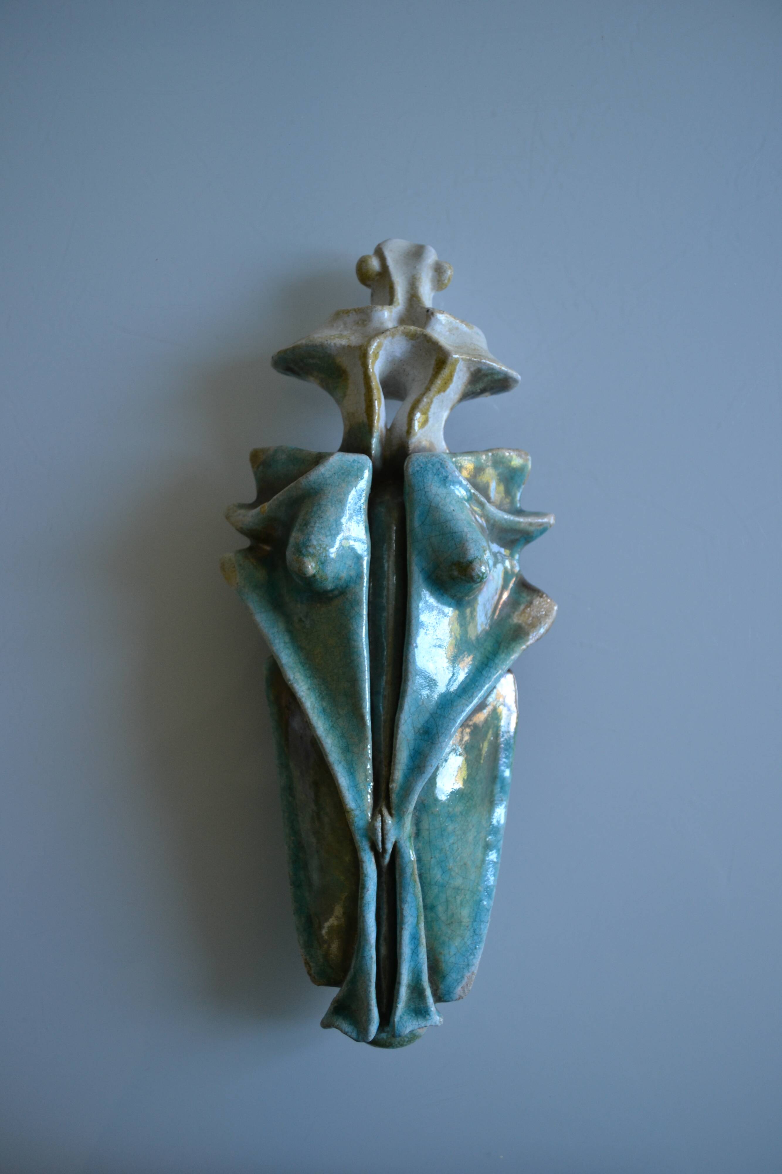 Surreal ceramic sculpture in relief signed to be identified.