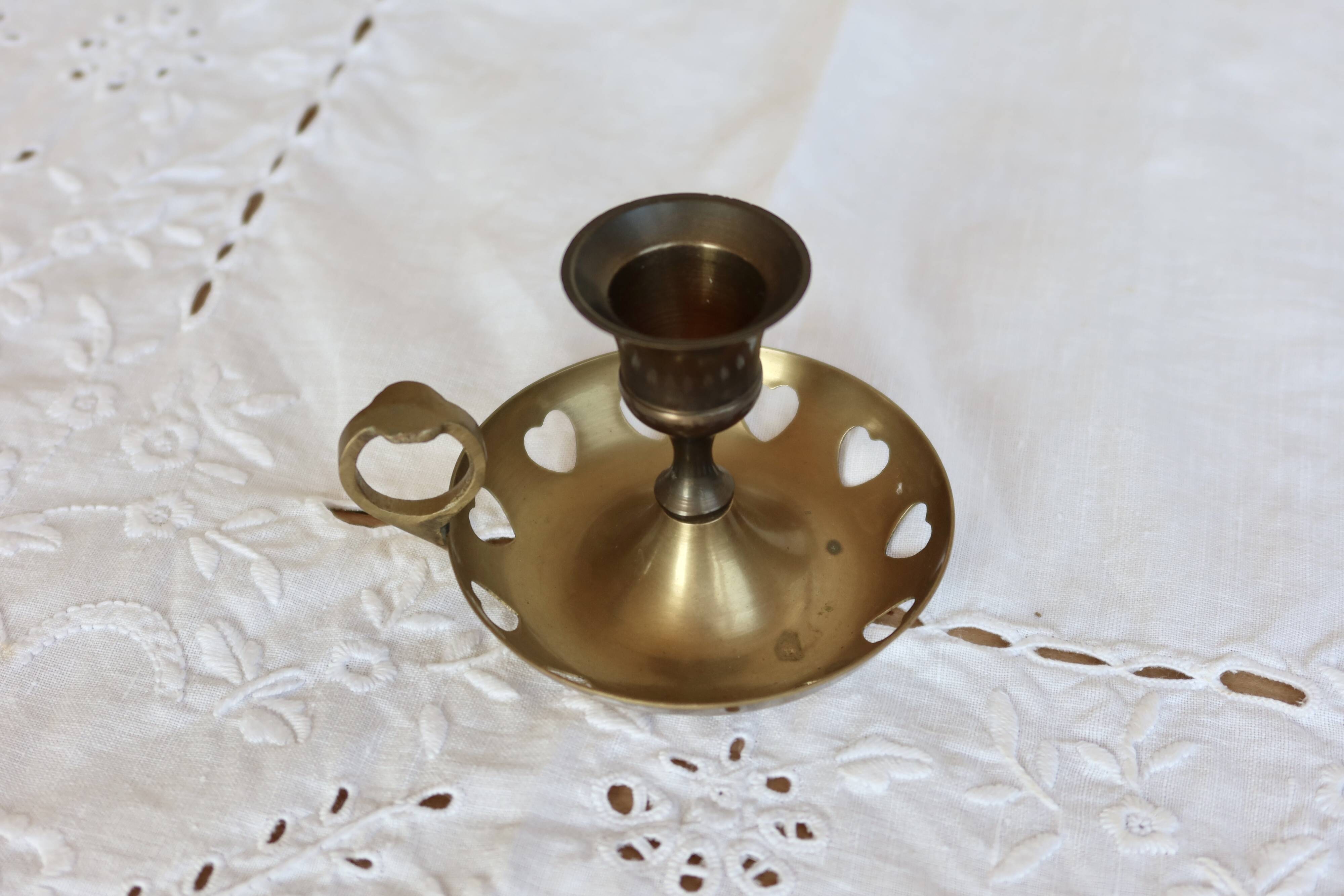 Antique brass rat trap with heart patterns.