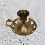 Antique brass rat trap with heart patterns.