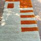 Handmade orange and white wool rug, traditionally crafted, size 140 x 260 cm