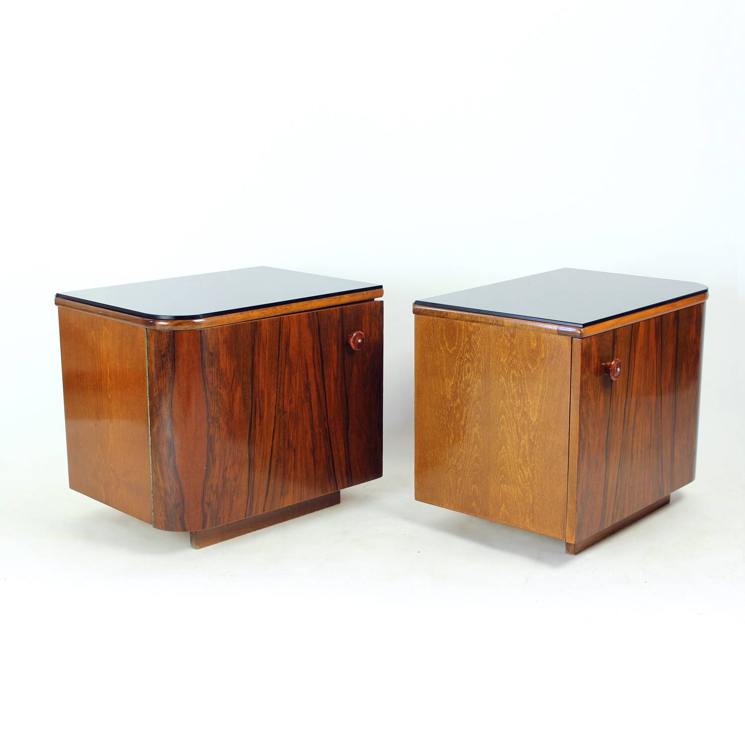 Pair of Art Deco bedside tables in walnut and black glass, Czechoslovakia.