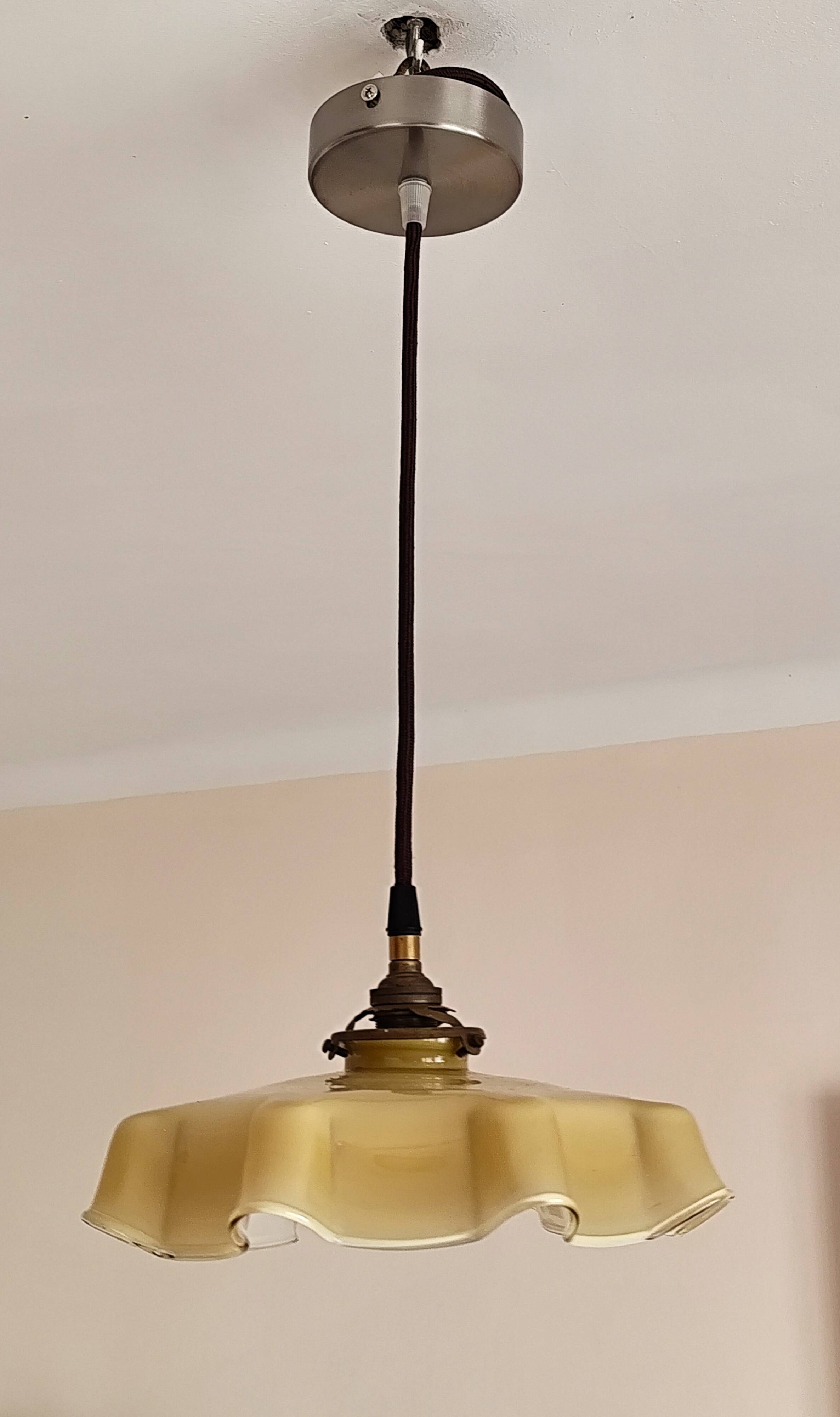Electrified suspension with a frosted opaque glass disc shade.