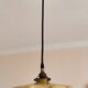 Electrified suspension with a frosted opaque glass disc shade.