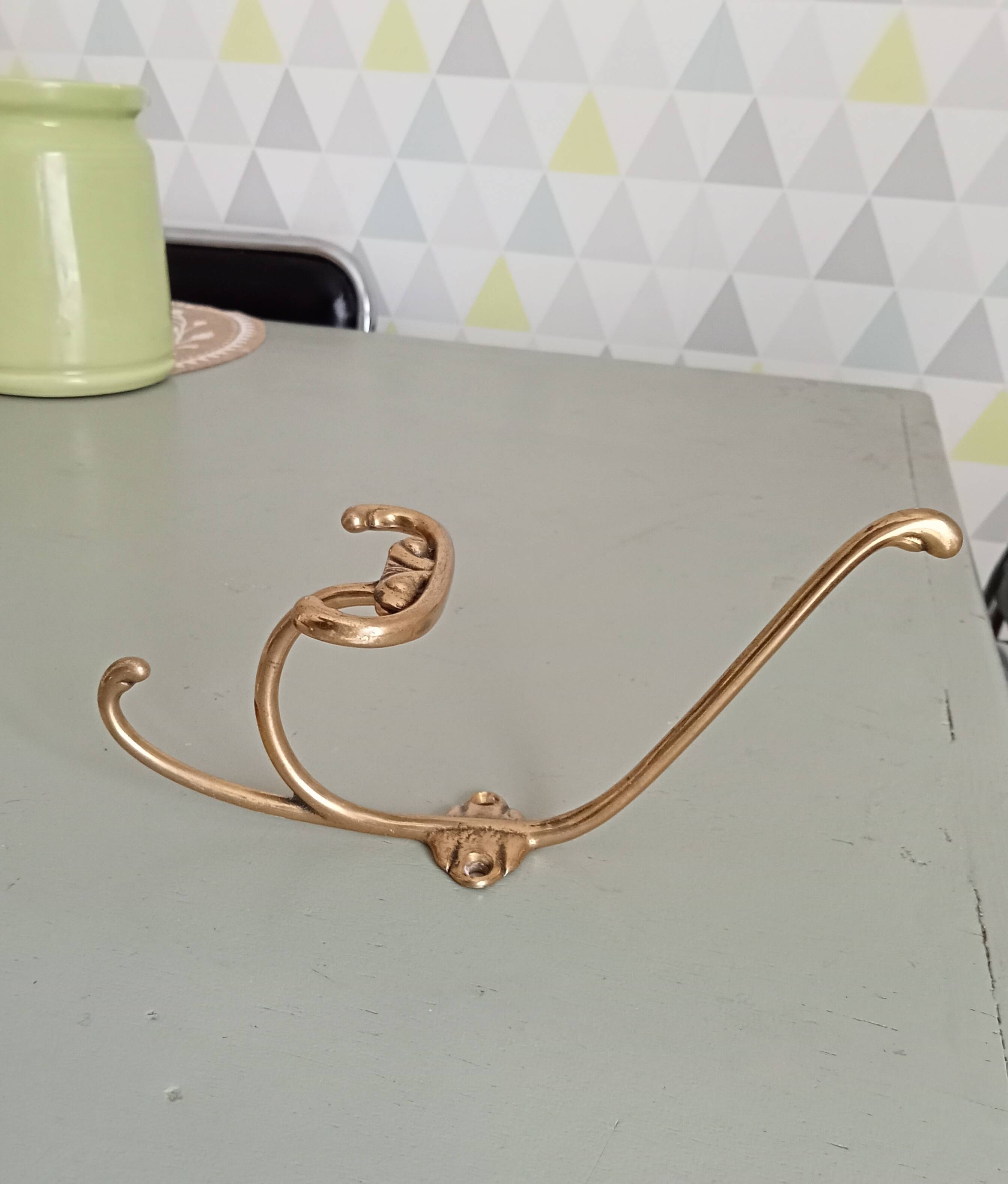 Old coat hook in solid golden brass