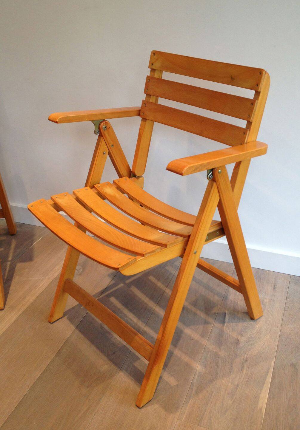 Pair of varnished wooden folding armchairs signed Clairitex.