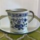 Stoneware milk jug with flower decoration
