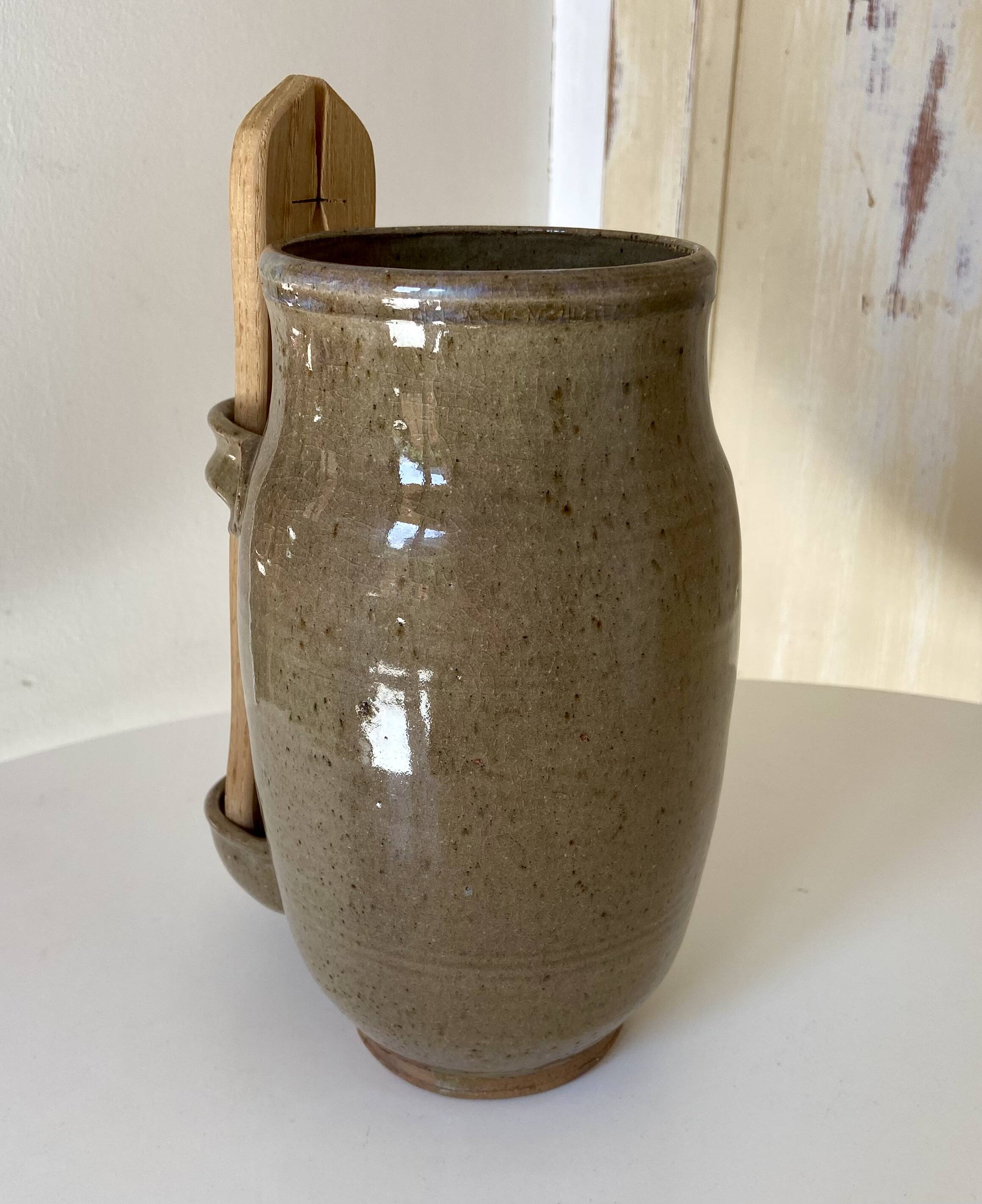 Old varnished stoneware pickle pot with tongs