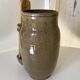 Old varnished stoneware pickle pot with tongs