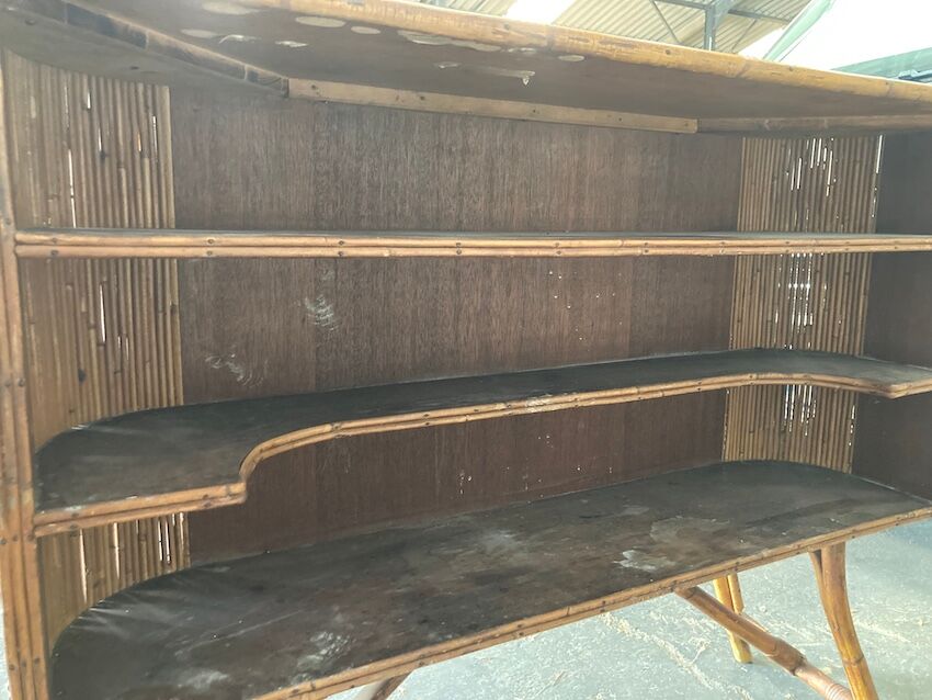 Rattan and wood bar with its decorative brass portholes