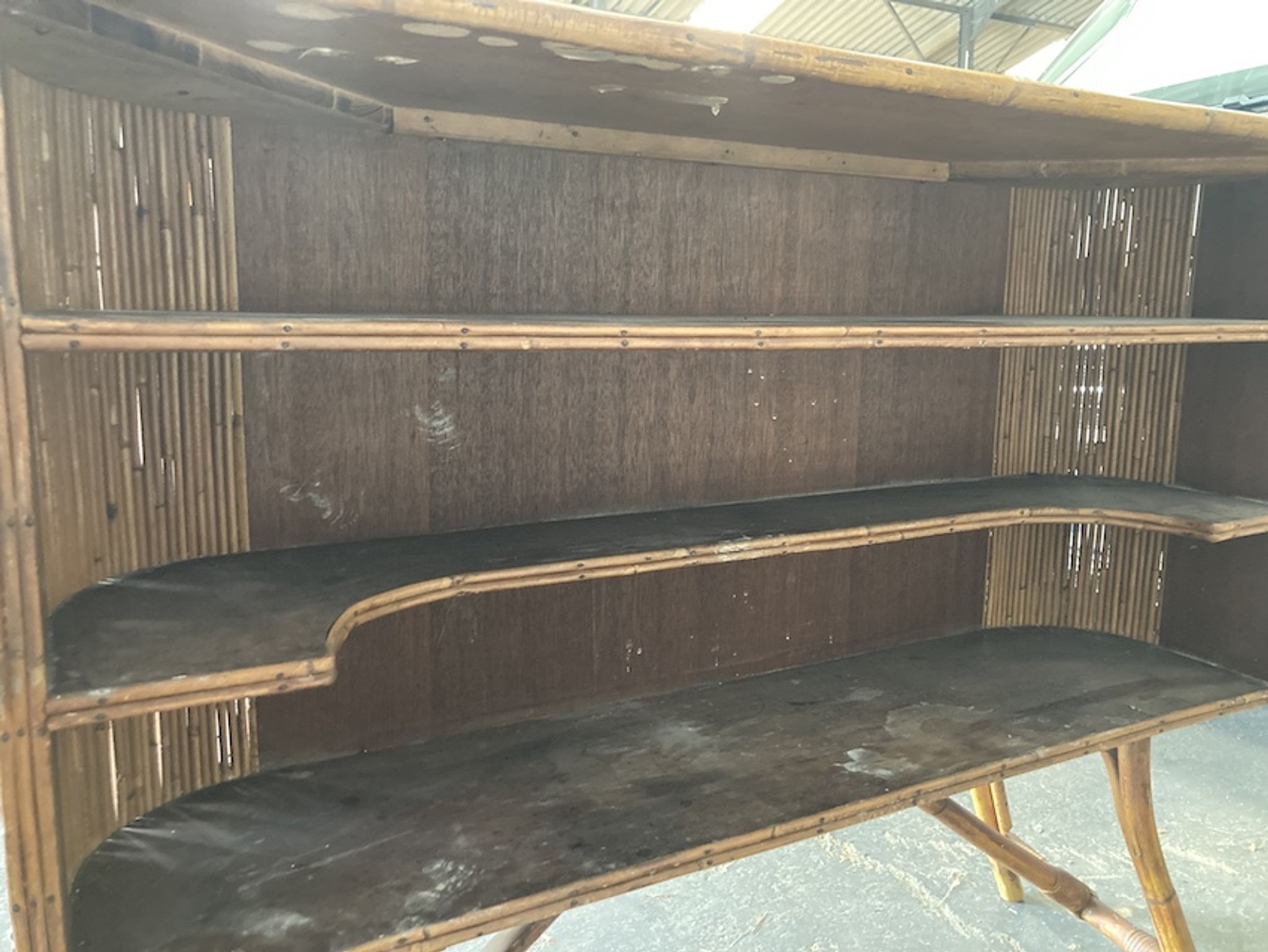 Rattan and wood bar with its decorative brass portholes