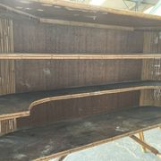 Rattan and wood bar with its decorative brass portholes