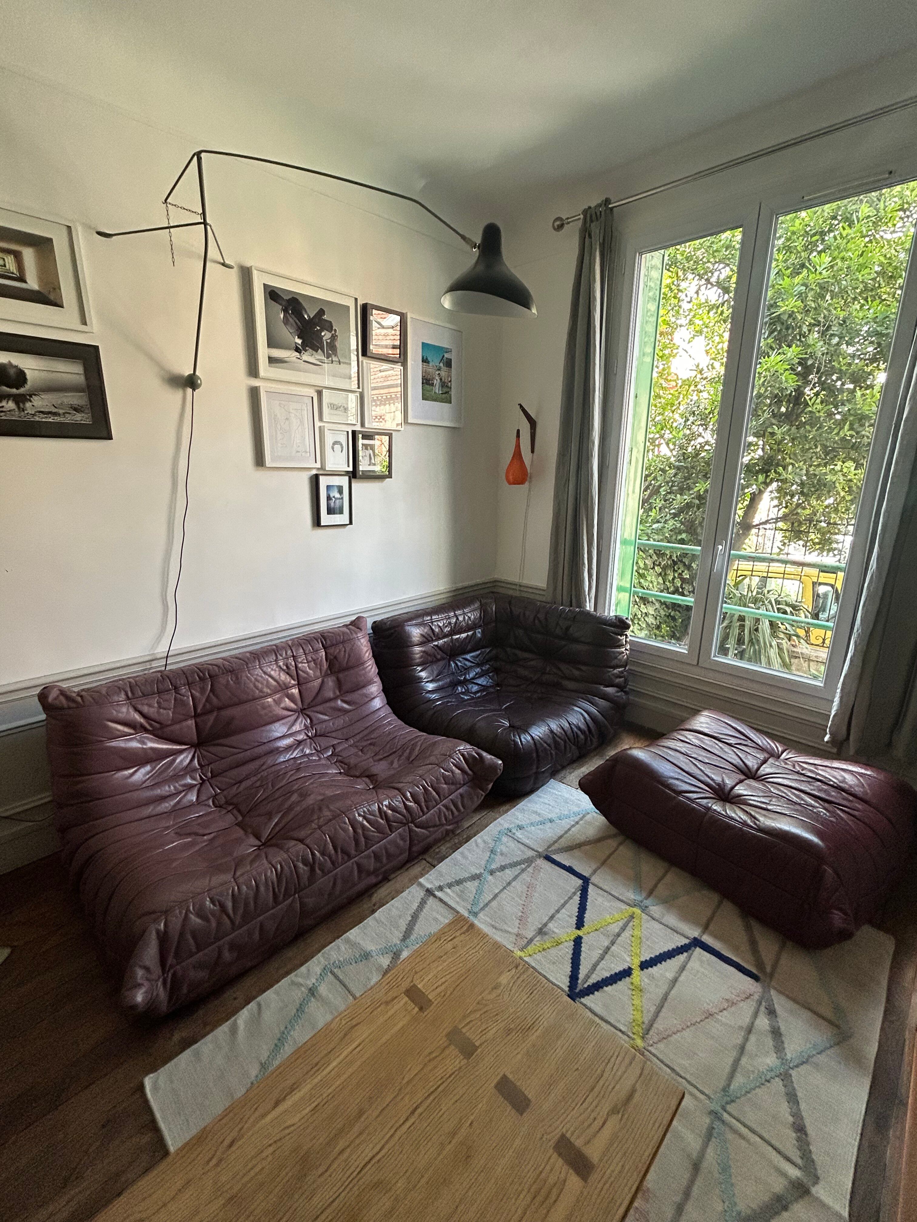 Togo set by Ligne Roset in vintage pink, plum, and burgundy leather.
