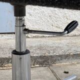 Black mottled fabric and chrome swivel armchair, 1