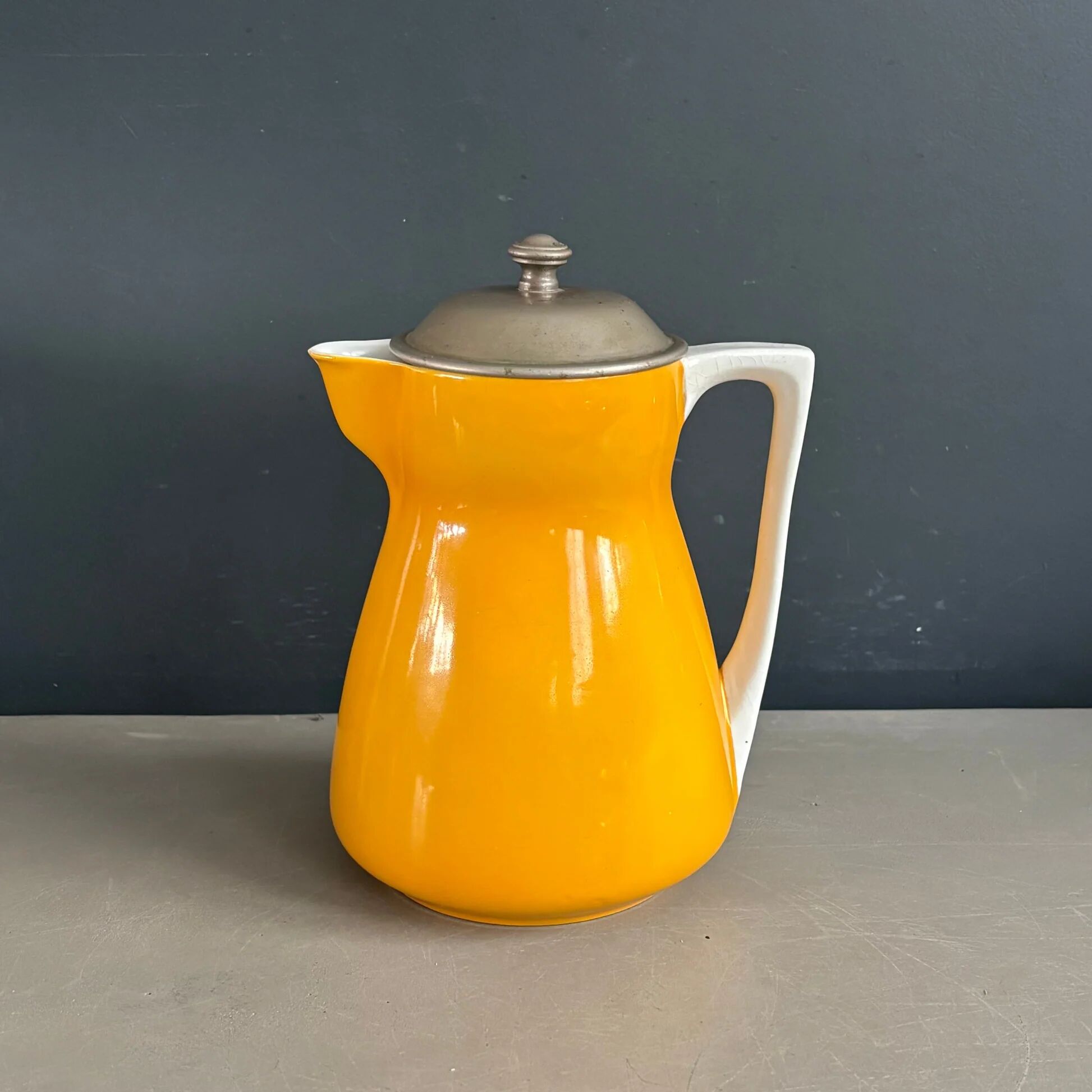 Antique teapot in earthenware with a tin filter lid.