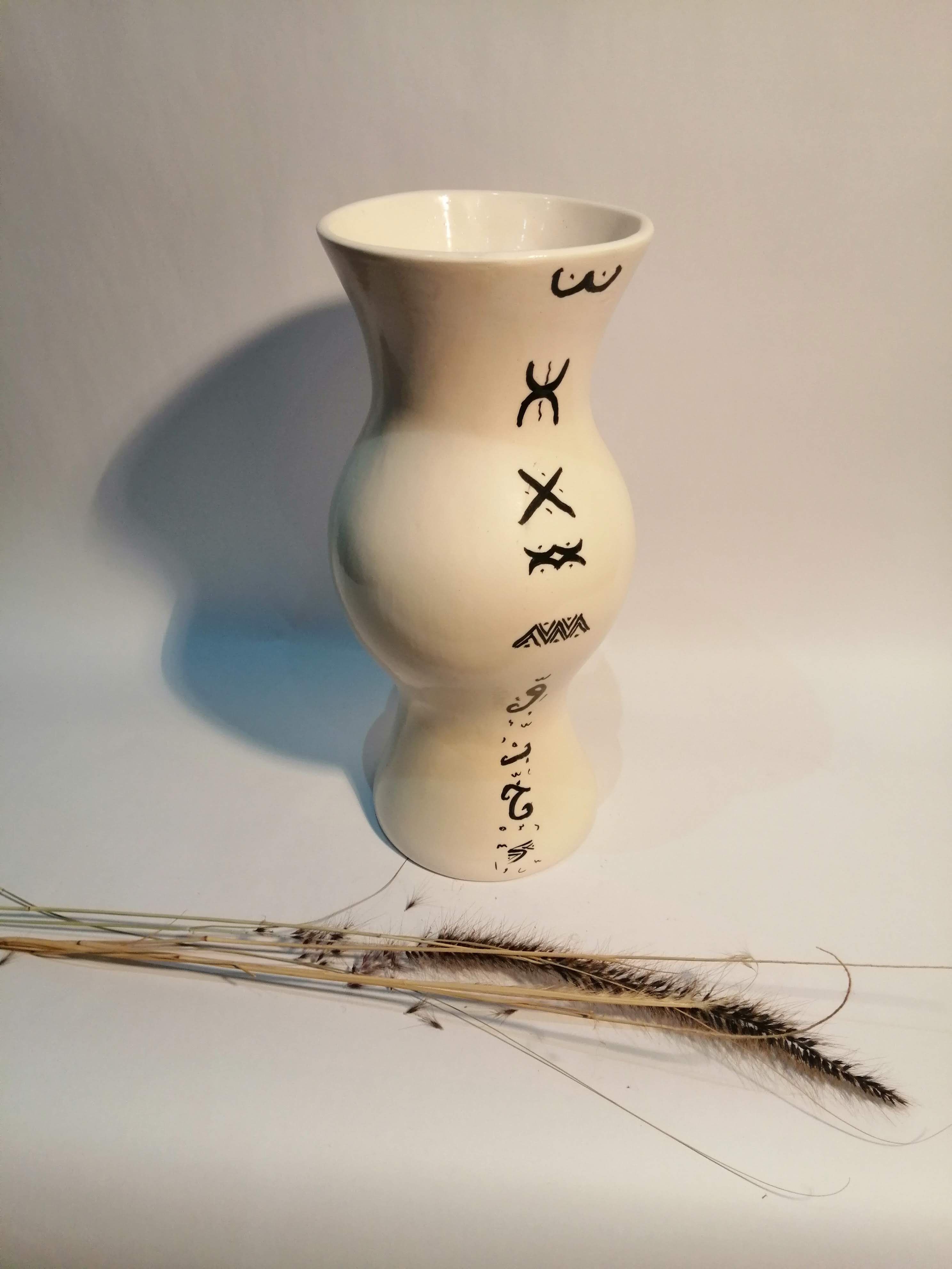 Vase is decorated in white clay;han mad