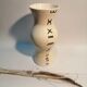 Vase is decorated in white clay;han mad