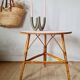 Round soft pink rattan table