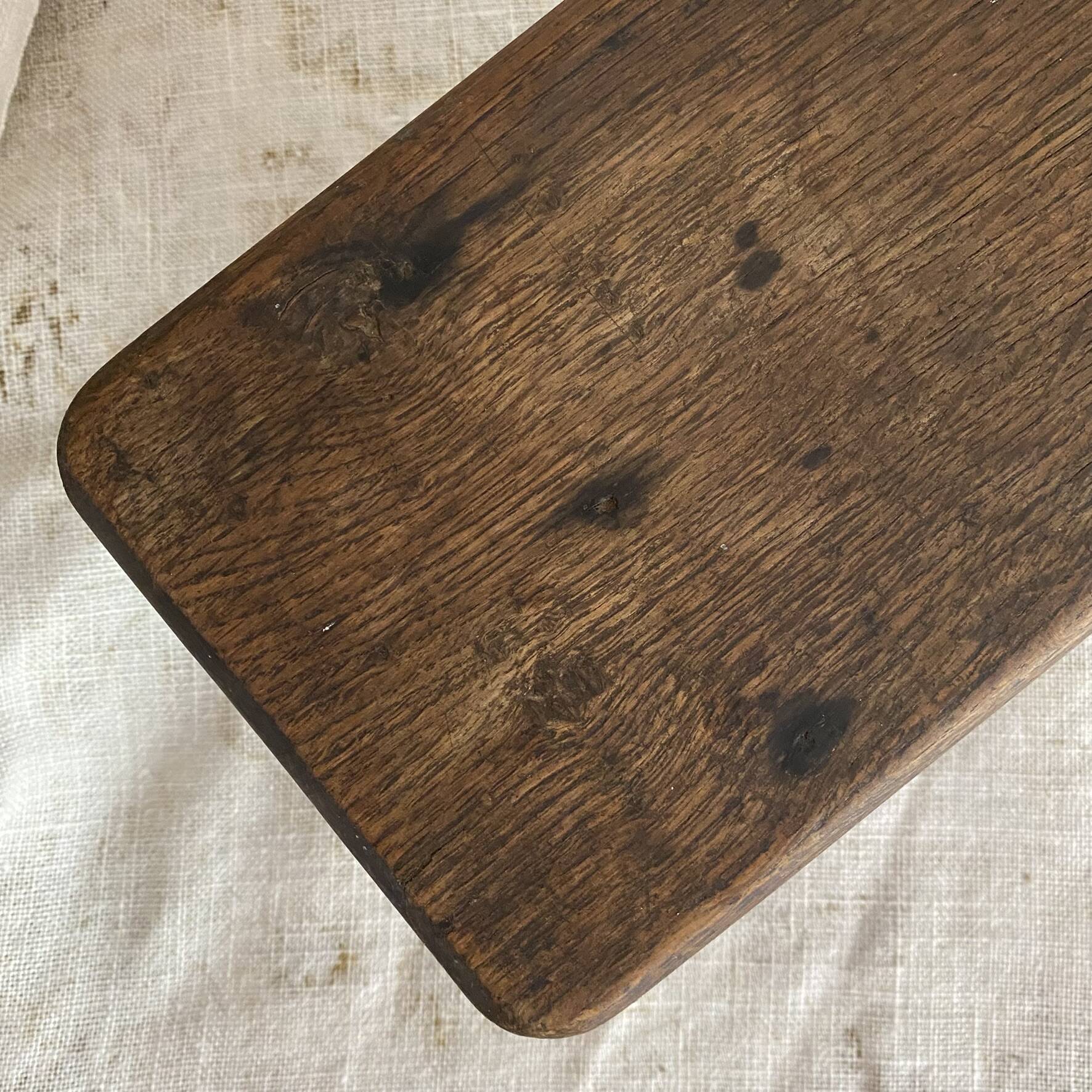 Old low stool made of solid wood
