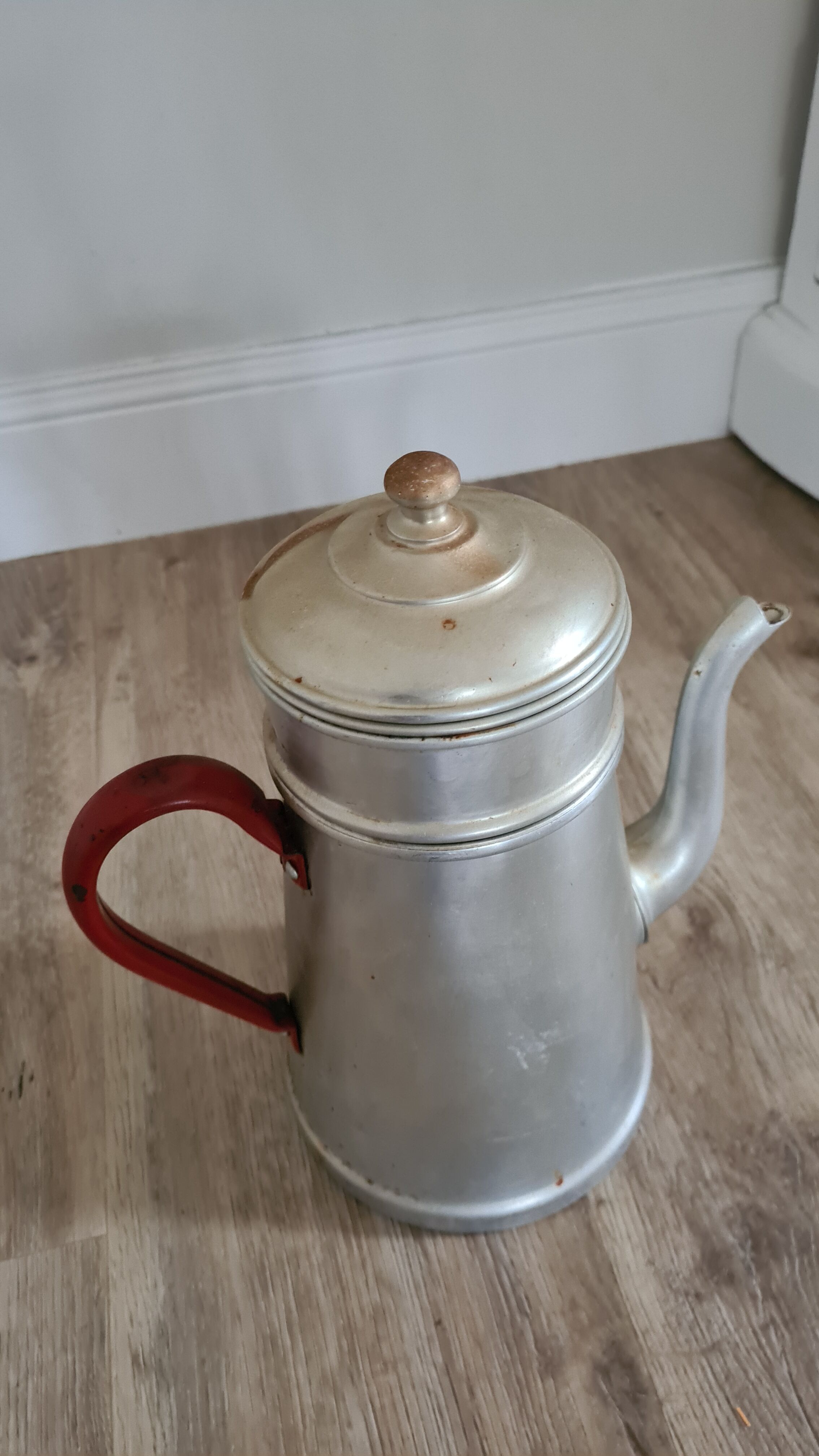 Old enamelled coffee maker in red handle aluminum