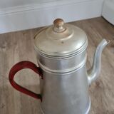 Old enamelled coffee maker in red handle aluminum