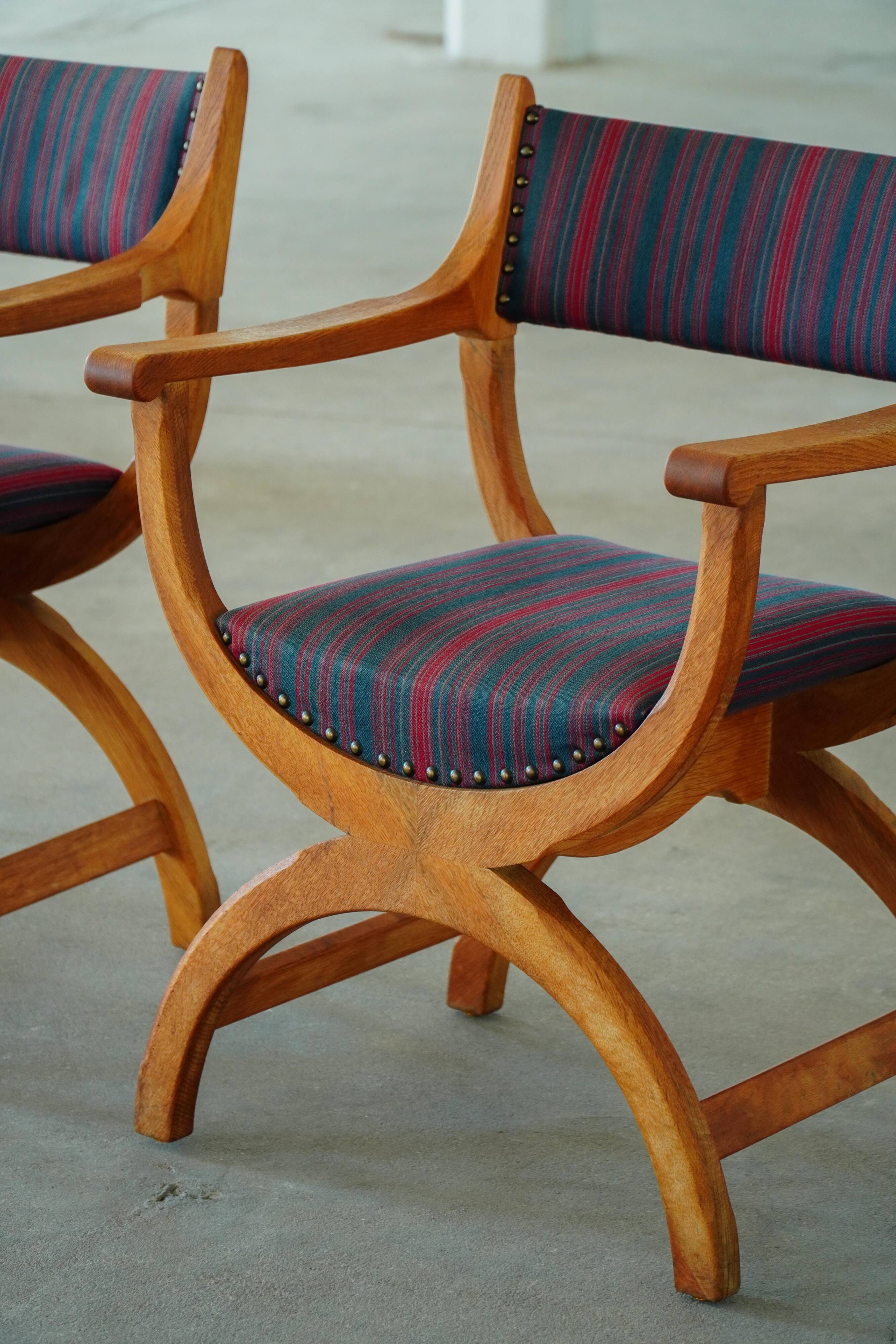 Henning Kjærnulf, pair of oak armchairs, model "Kurul", Danish modern style, 1960s.