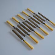 11 antique 19th-century table knives with ivory-colored monogram handles
