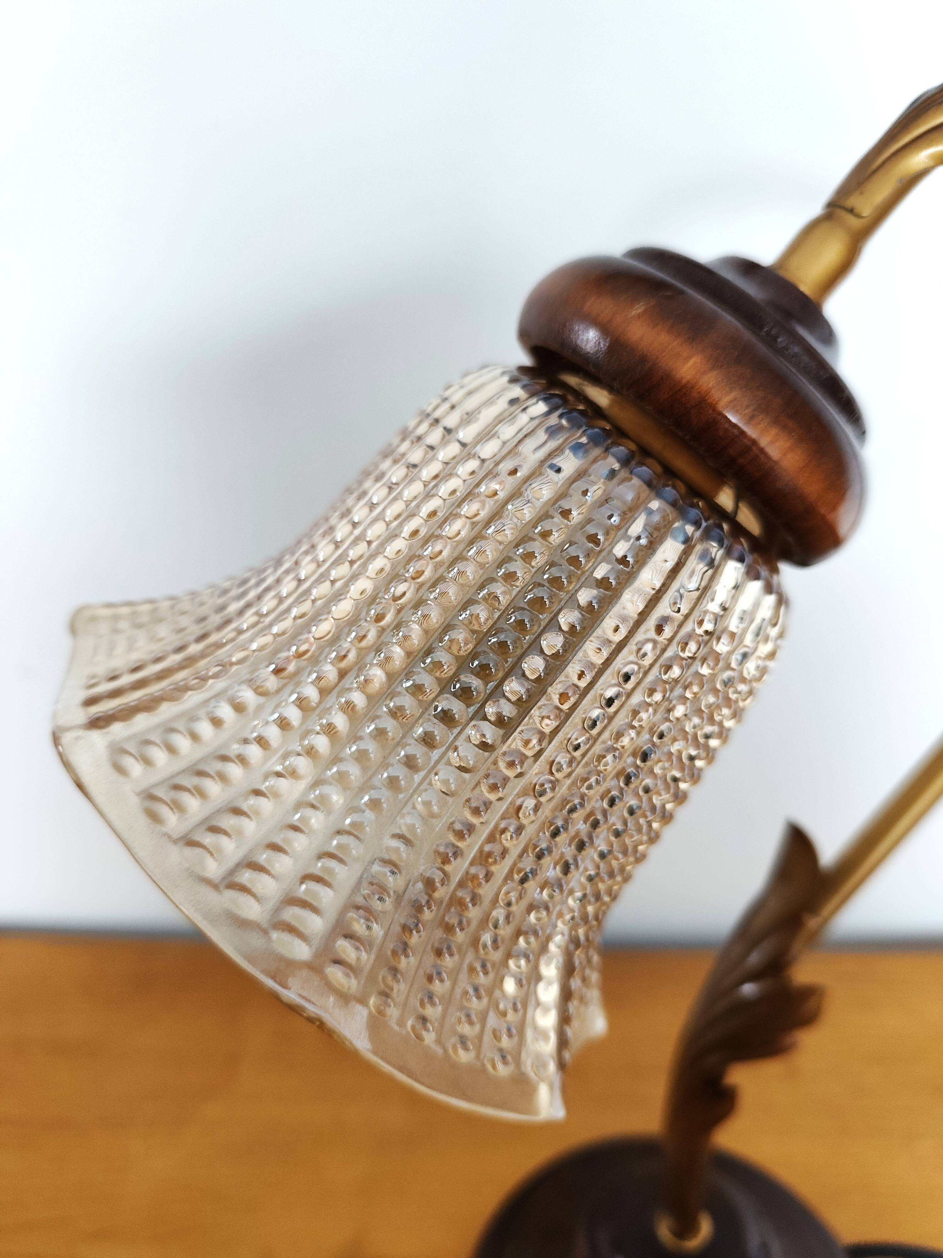 Gold swan neck table lamp with amber tulip glass.