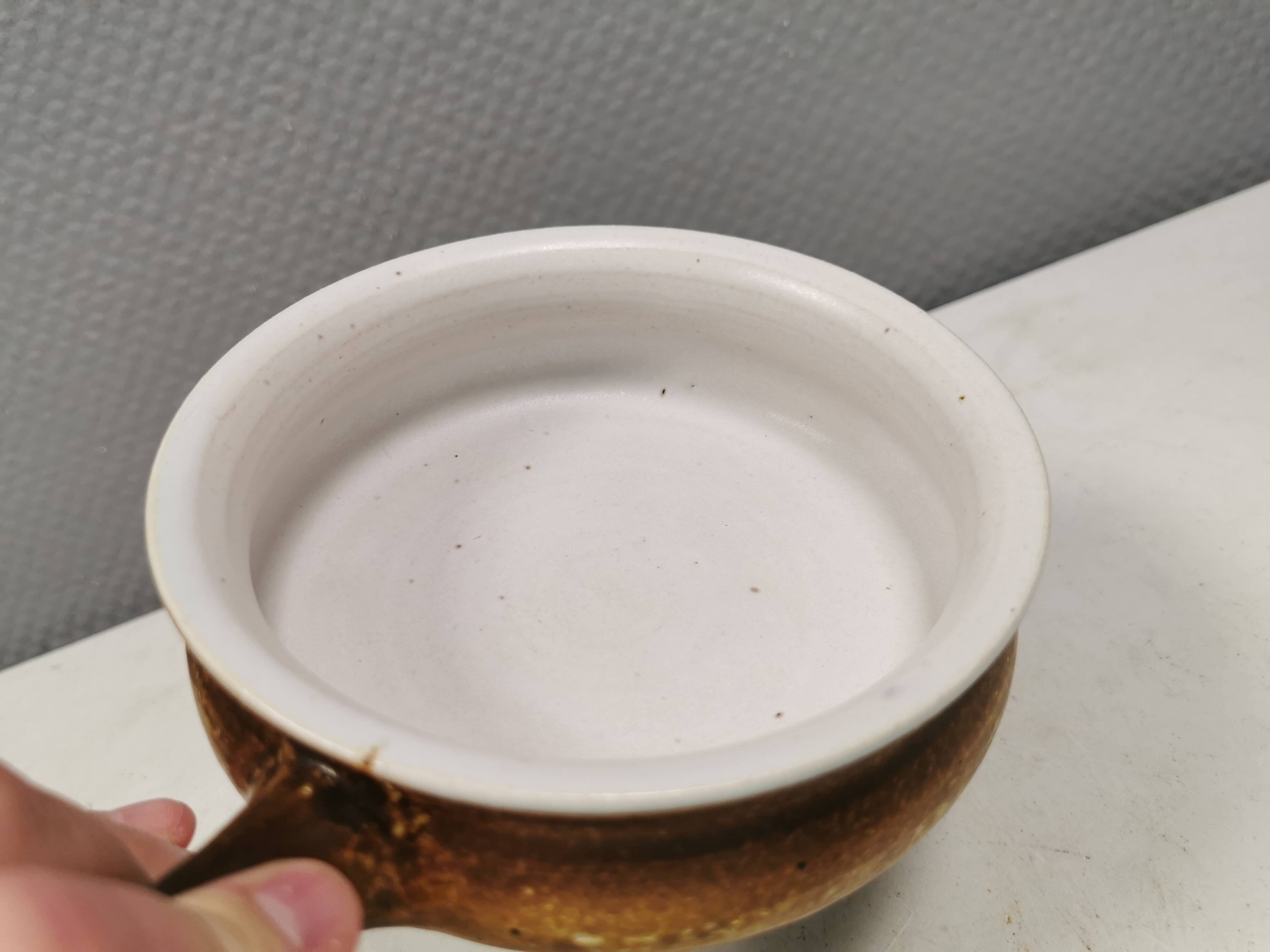 Small ceramic bowl with handle, in golden colours. Danish 1960-70s