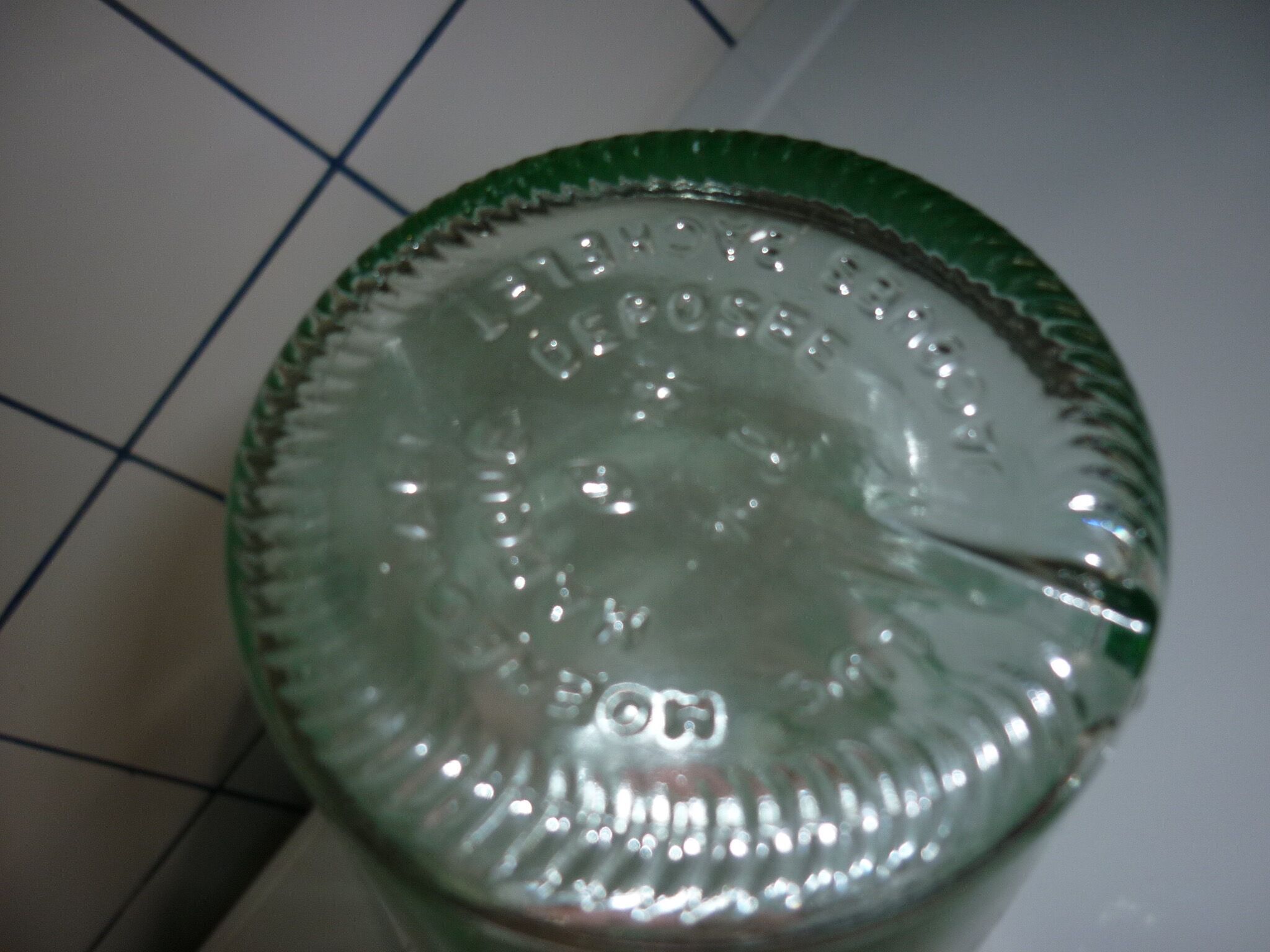 Old transparent moulded glass bottle