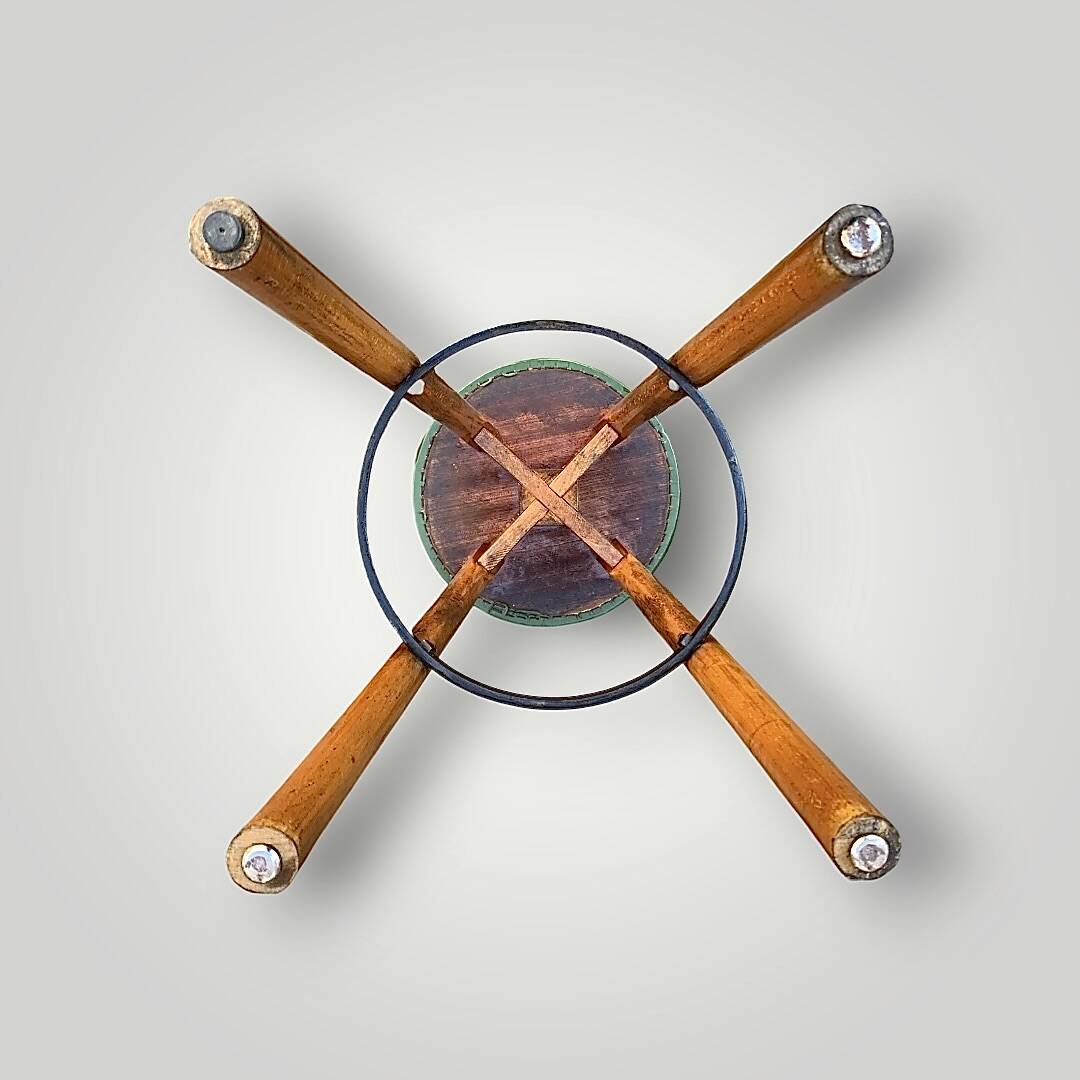 Old solid wood bar stool, metal footrest, green leatherette seat