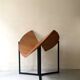 Modernist round folding dining table in wood and metal.