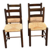 4 solid oak chairs in dark colour with elephant upholstery.