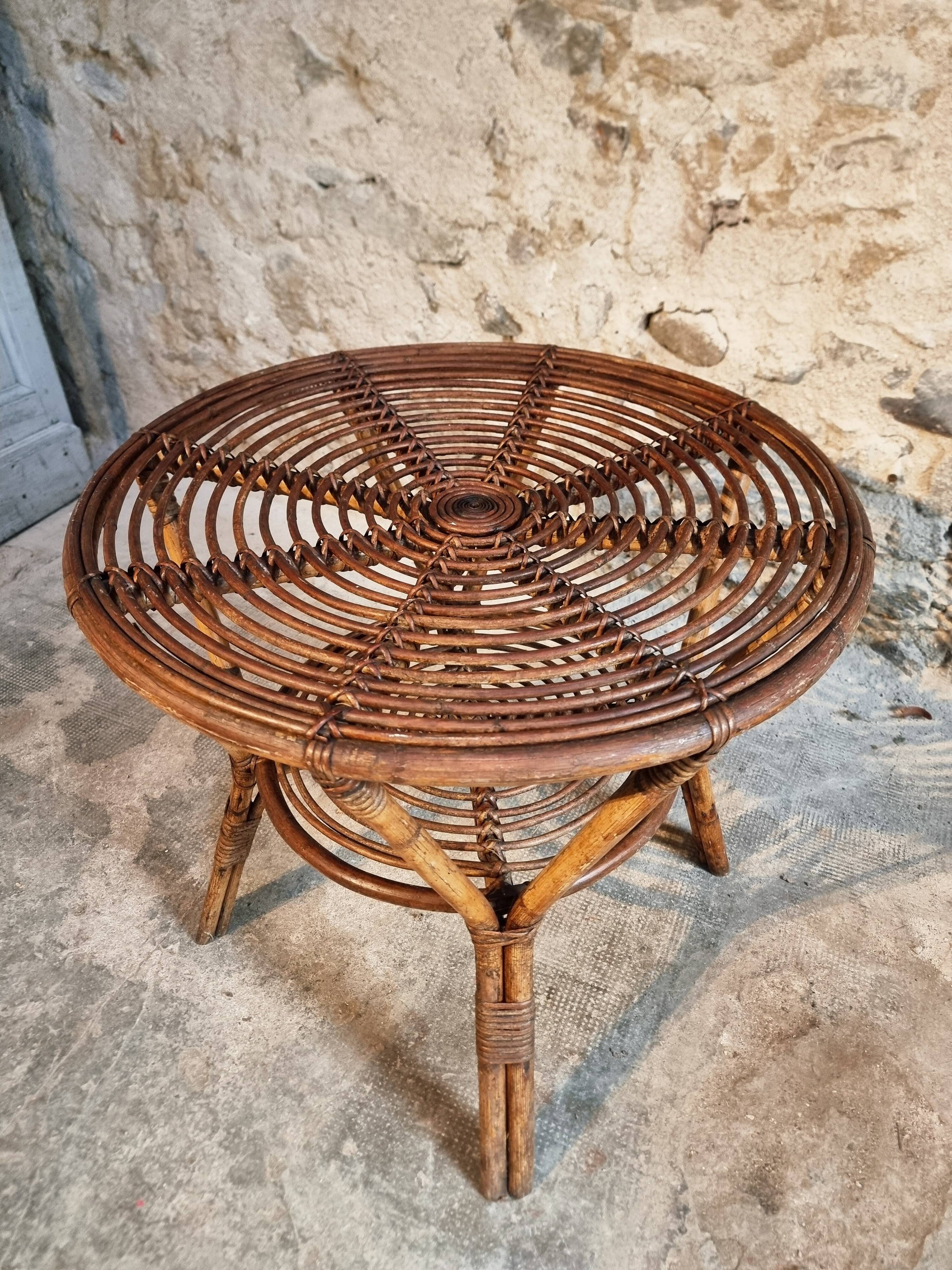 Vintage rattan lounge set, French wicker armchairs and round table, circa 1930–1950.