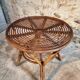 Vintage rattan lounge set, French wicker armchairs and round table, circa 1930–1950.
