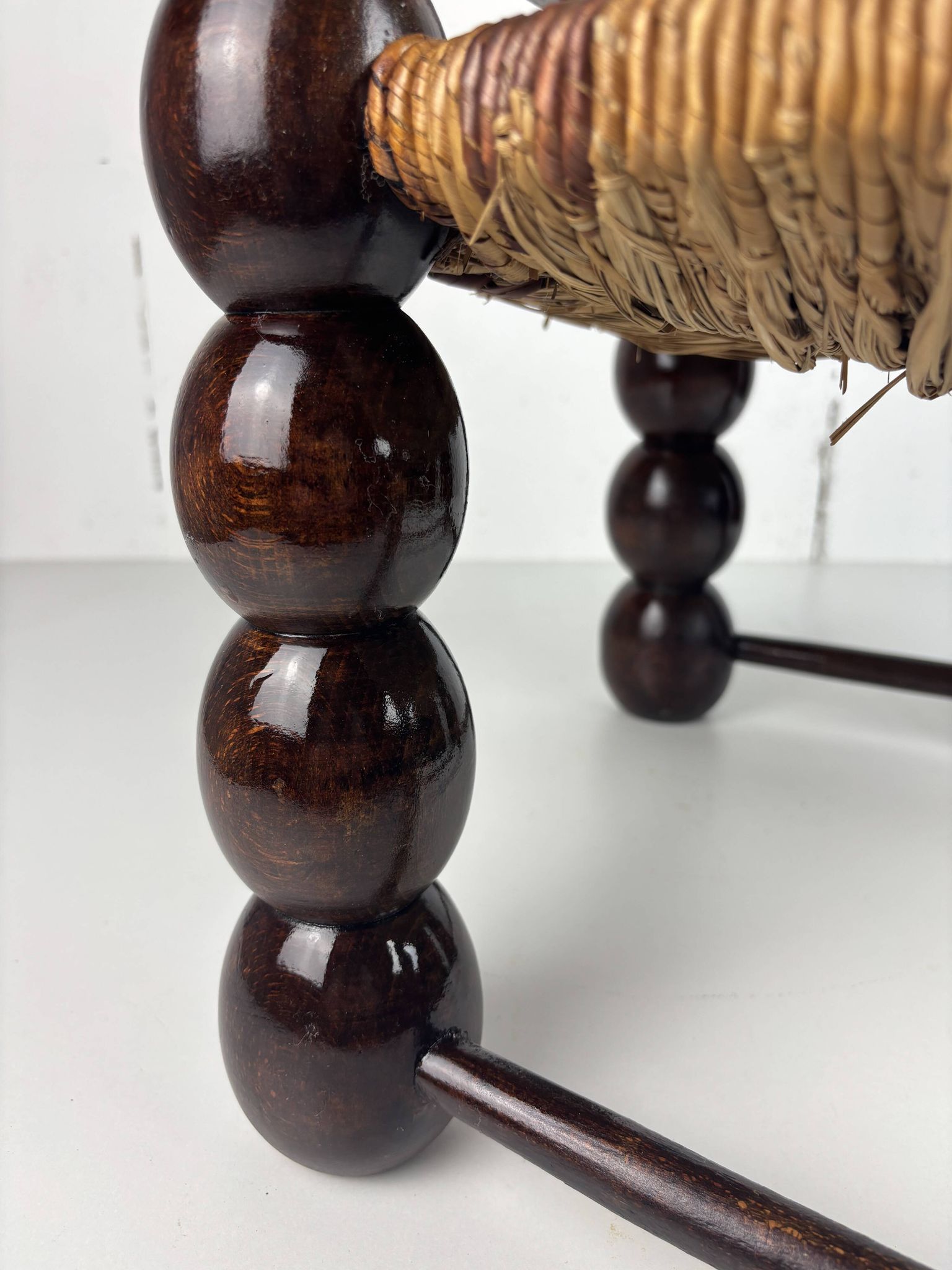Brutalist wood turned bobbin low rush chair n the style of Charles Dudouyt