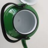 Old green kettle in enamelled metal