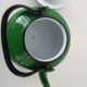 Old green kettle in enamelled metal