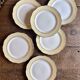 Set of 6 vintage white dinner plates with yellow and gold trim.