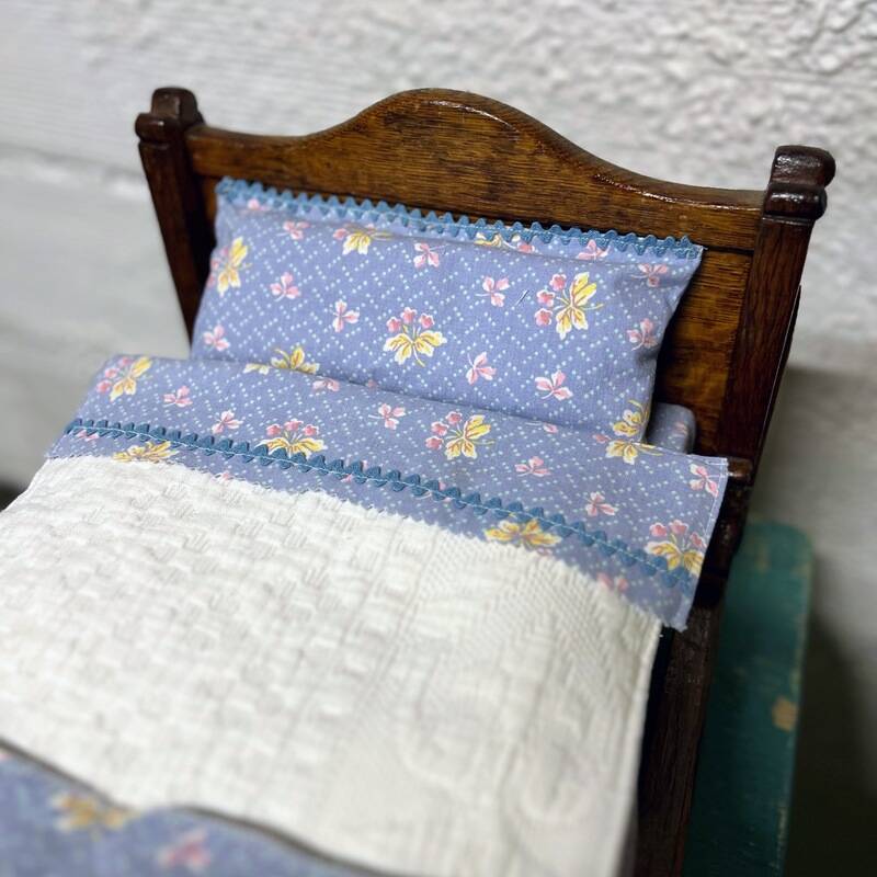 Old doll's bed in varnished wood