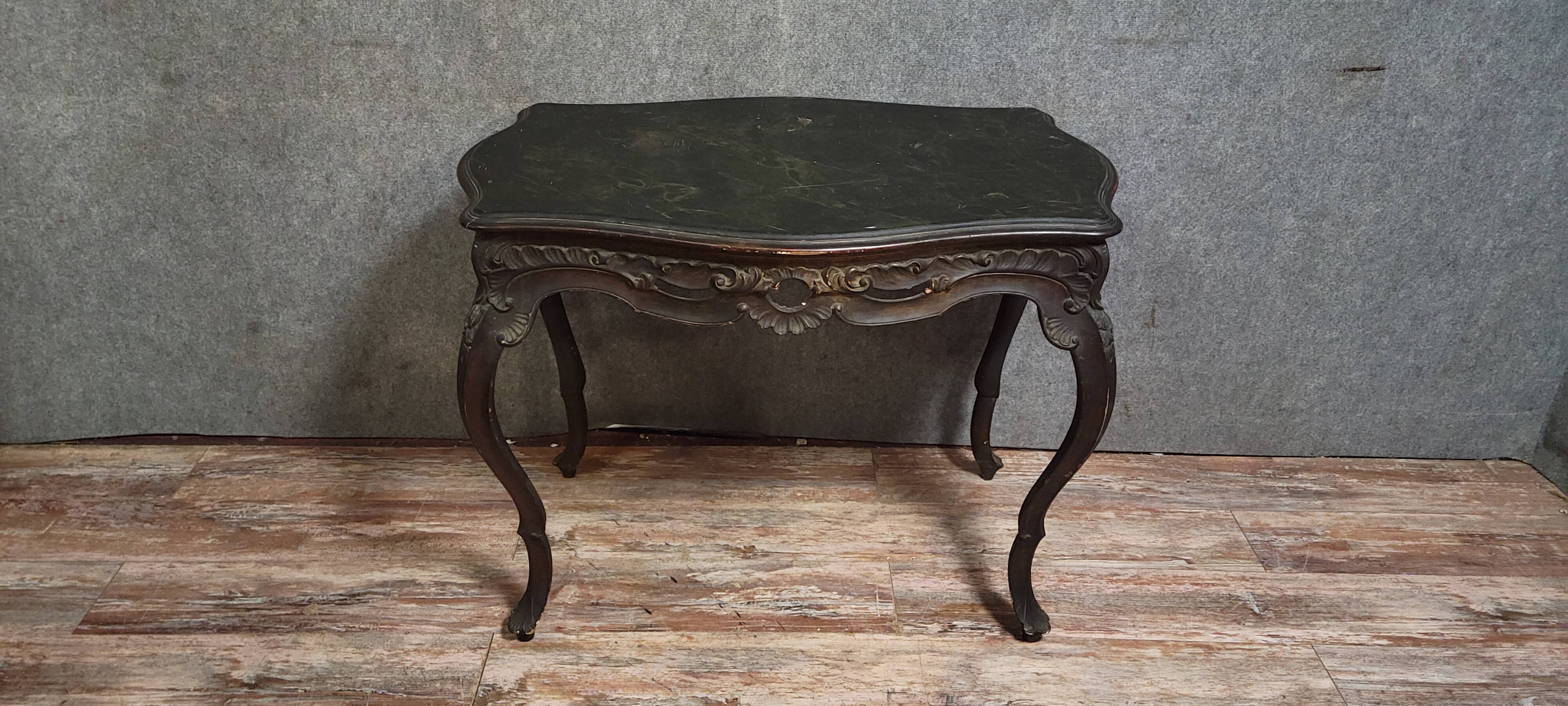 Antique desk in the Louis XV style, resting on four curved legs.