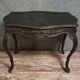 Antique desk in the Louis XV style, resting on four curved legs.