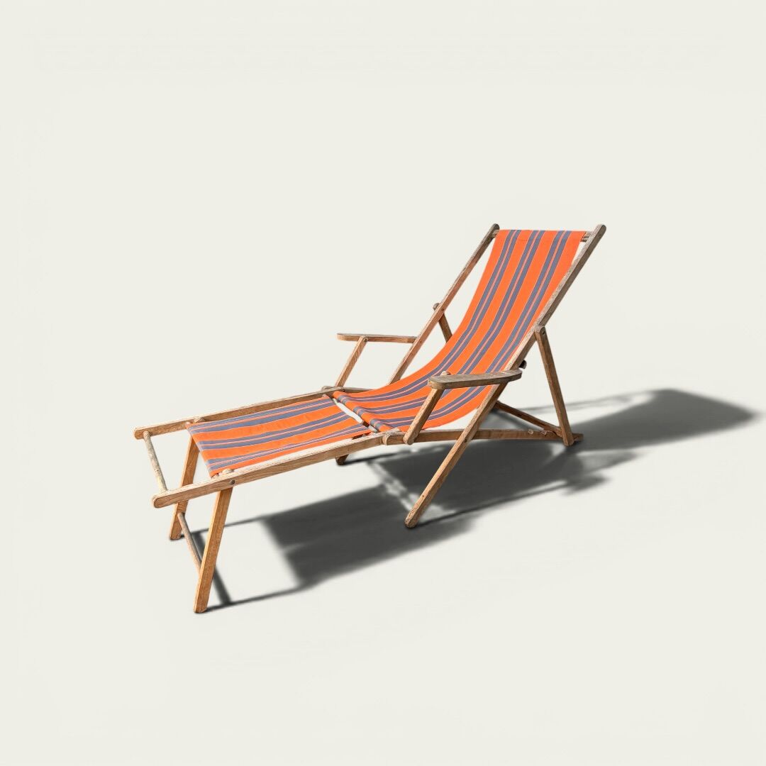 Vintage deck chair with orange and grey striped fabric, original patina.