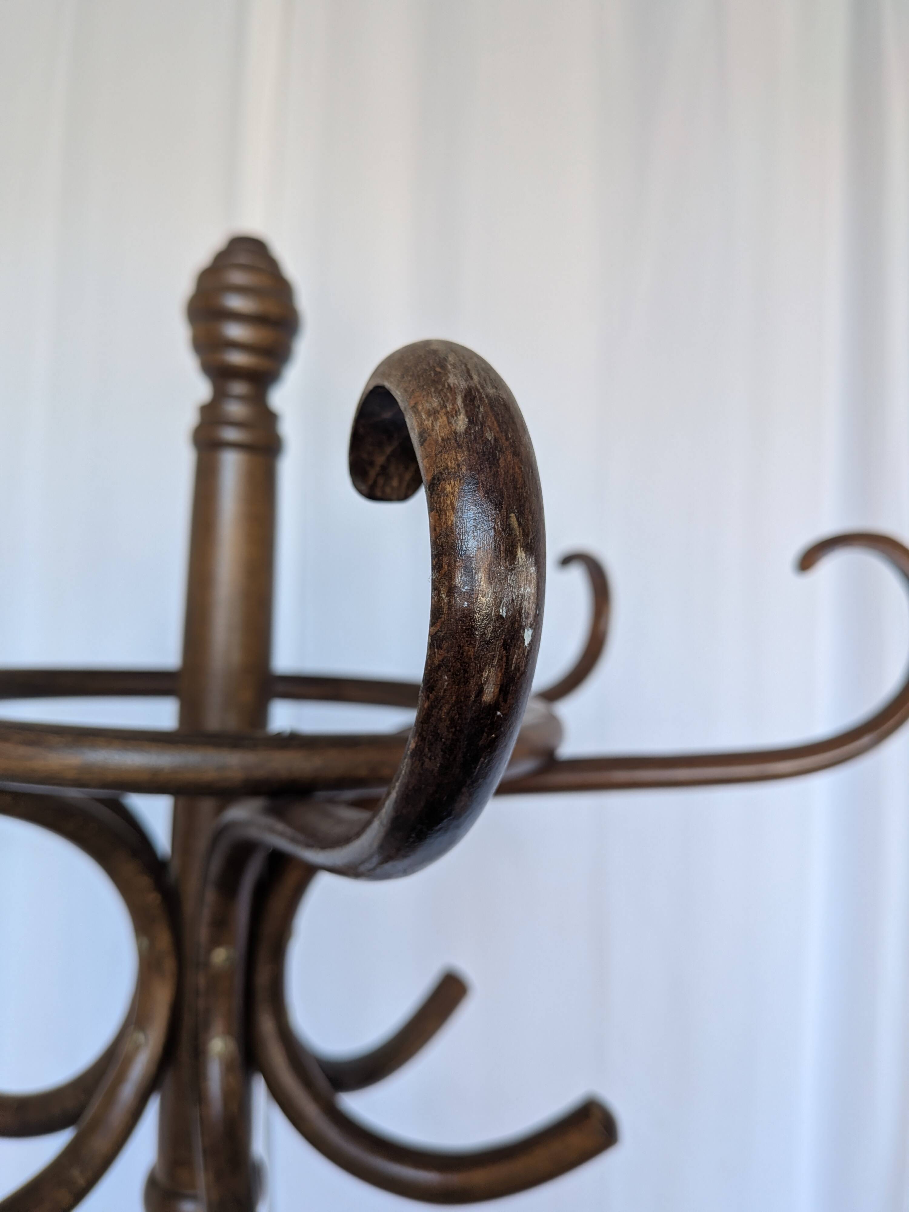 Vintage bentwood coat rack in Thonet style / Dark wood coat rack with shadow.