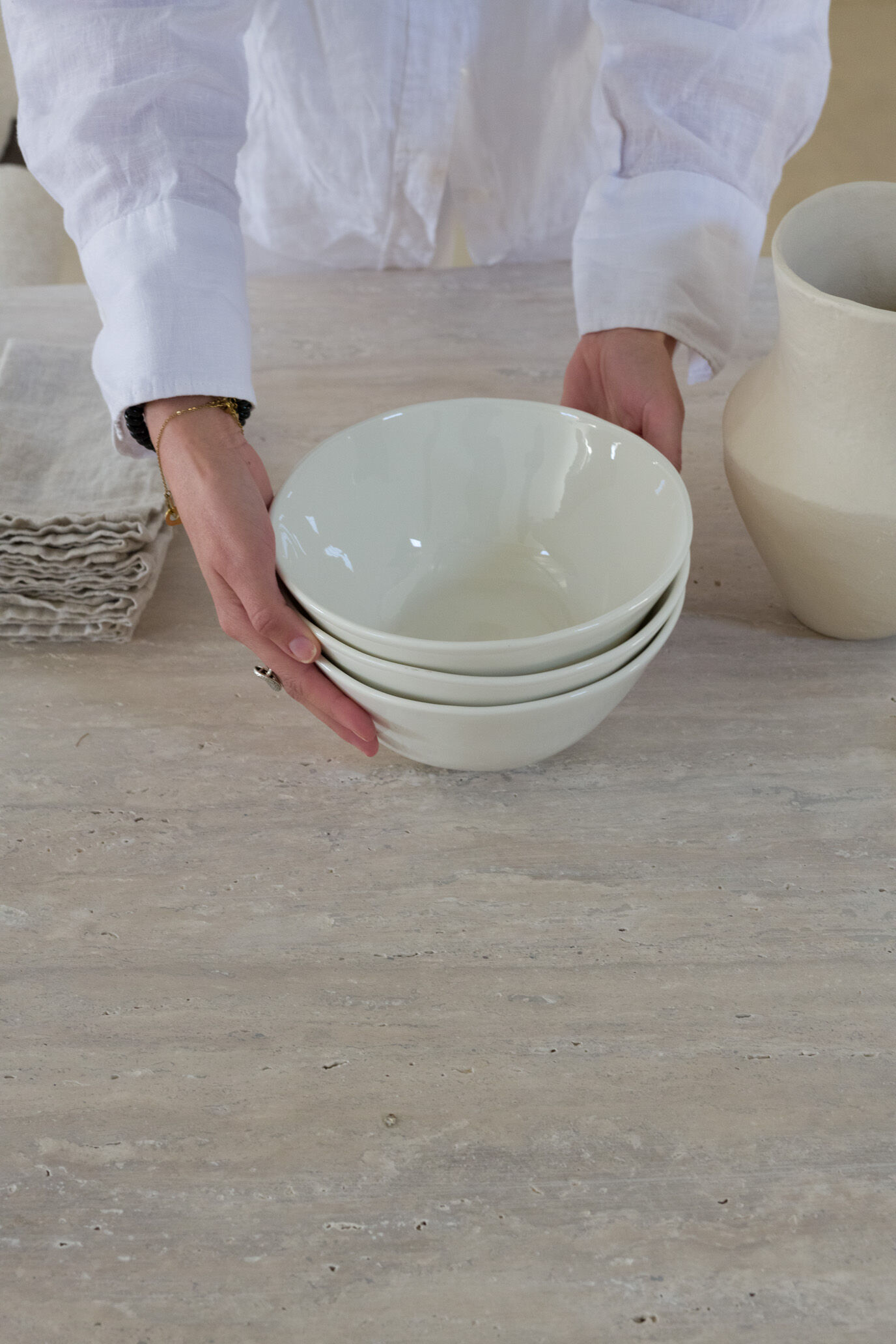 Omega circular dining table in natural travertine