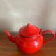 Red enamelled sheet metal teapot