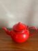 Red enamelled sheet metal teapot