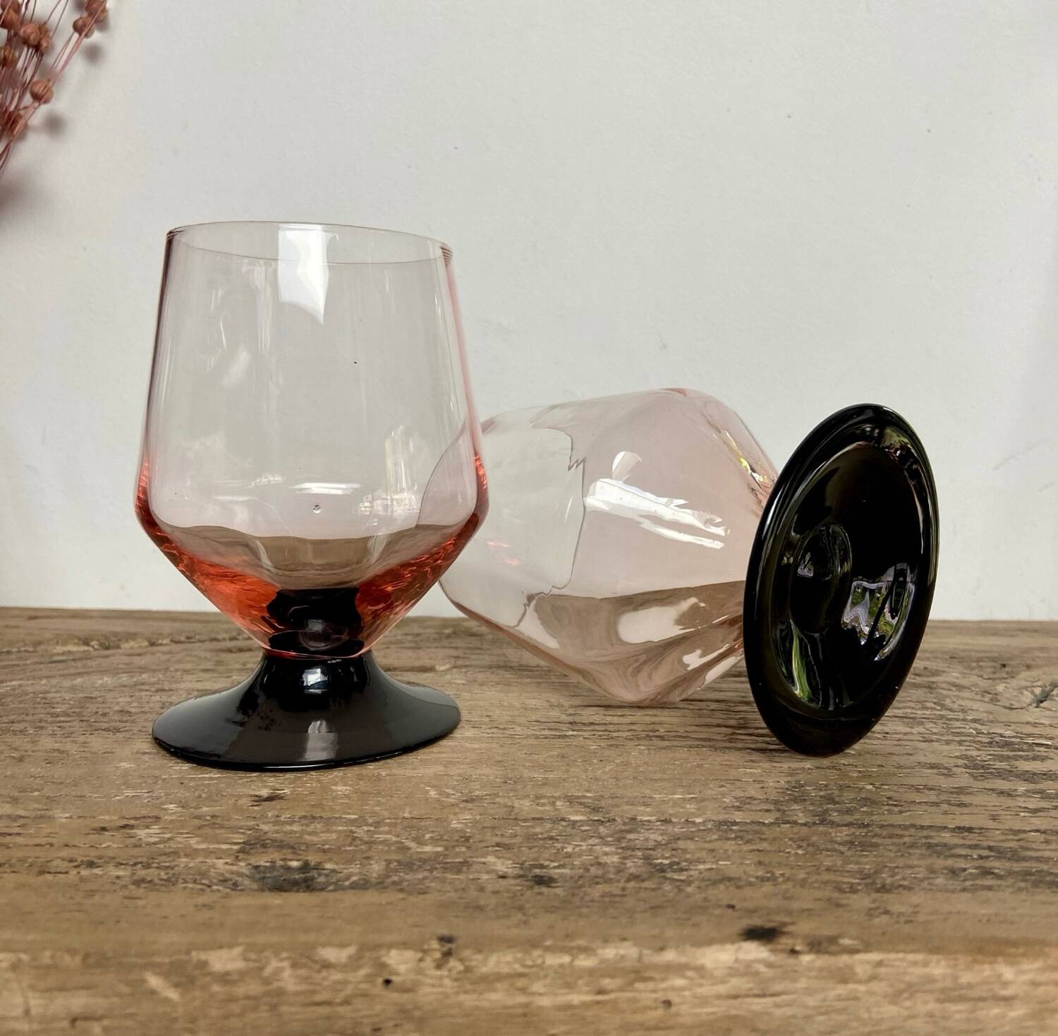 4 pink glasses with black stems