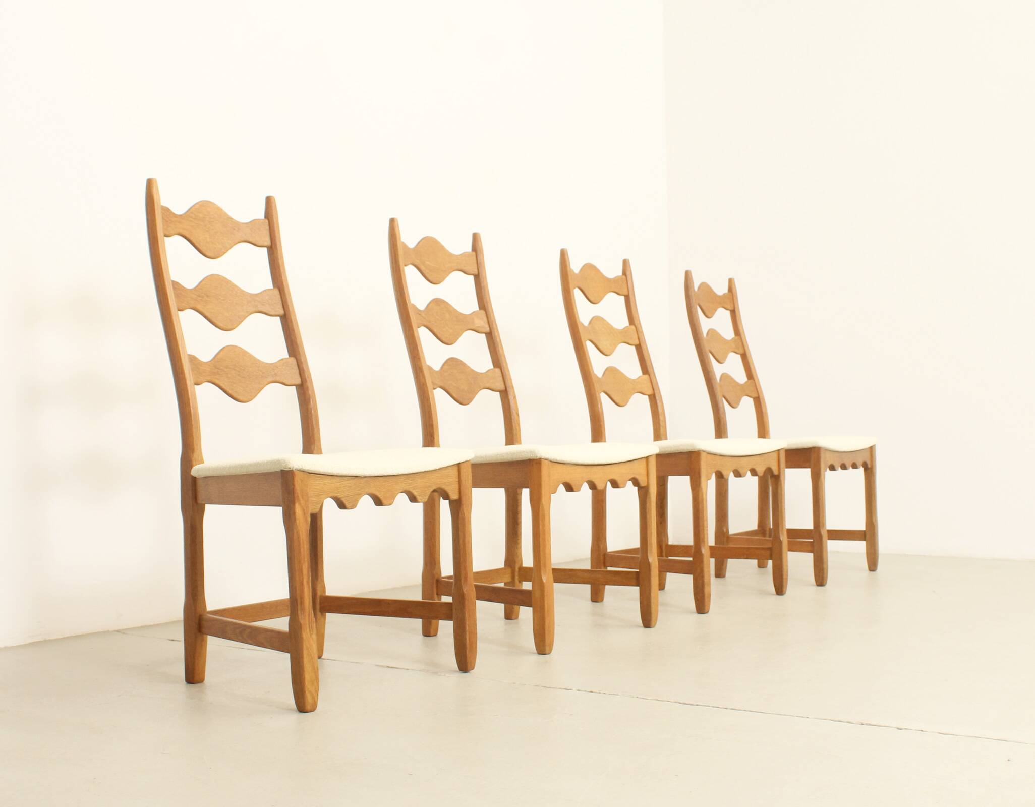 Four oak dining chairs by Henning Kjaernulf.