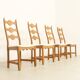 Four oak dining chairs by Henning Kjaernulf.